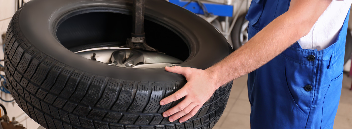 Mechanic holding a car tyre - Tyres Bethnal Green